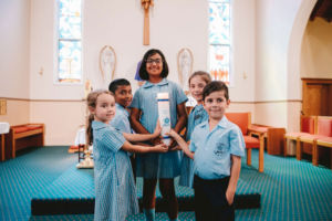 St Mary Star of the Sea Catholic Primary School Hurstville students holding school candle inside church