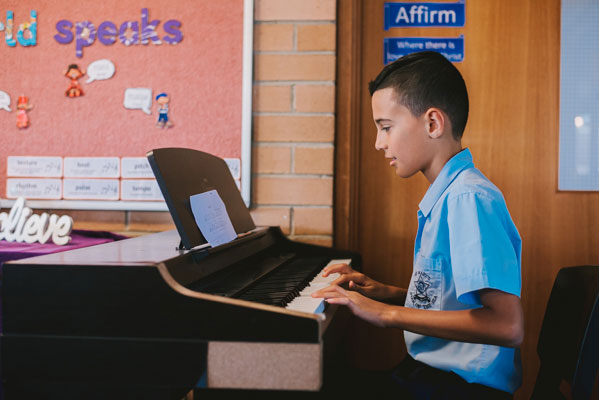 Student playing piano at St Mary Star of the Sea Catholic Primary School Hurstville