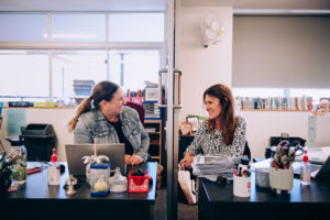Two staff chatting in office at St Mary Star of the Sea Catholic Primary School Hurstville